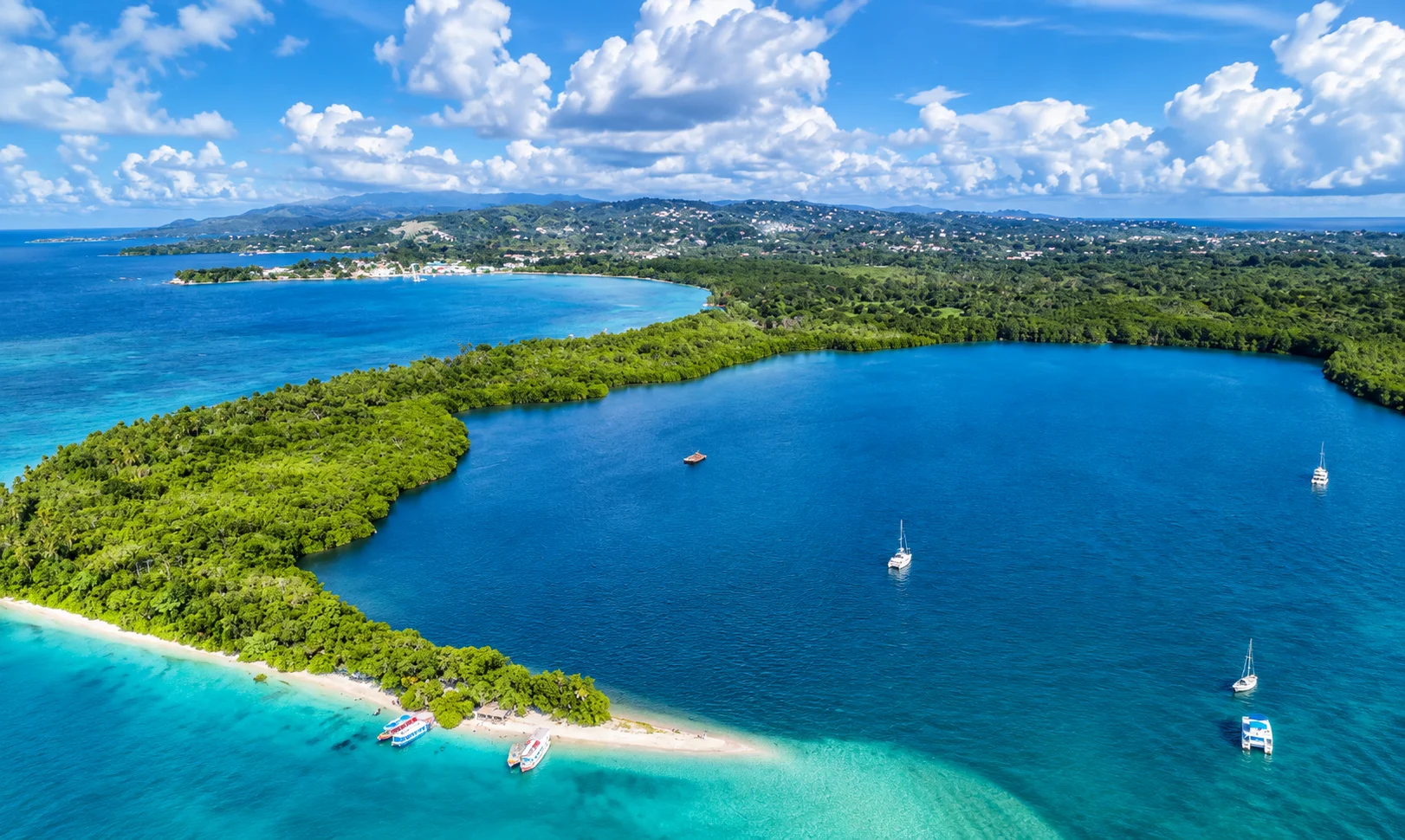 Aerial of a turquoise lagoon with sandbar and mangroves