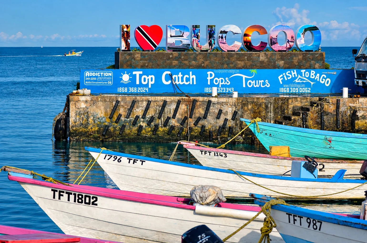 Fishing pirogues moored at Buccoo with the I Love Buccoo sign